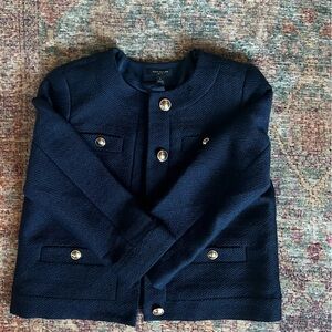 Navy blue crop jacket with gold accent buttons.